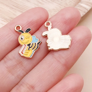 Detail view of double-sided cartoon bee charm showing enamel craft and rose gold back