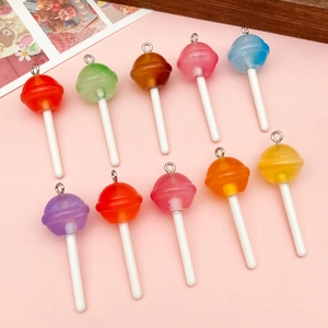 Macro shot of 10 colorful mini resin lollipop pendants with silver rings for DIY crafts