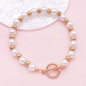 Détail d'un bracelet de perles blanches avec perles dorées et un fermoir à bascule chic