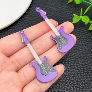 Close-up of purple acrylic electric guitar pendants for DIY jewelry and keychain making