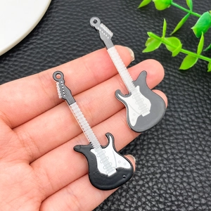 Macro view of black and white acrylic guitar pendants for DIY keychain and accessory making