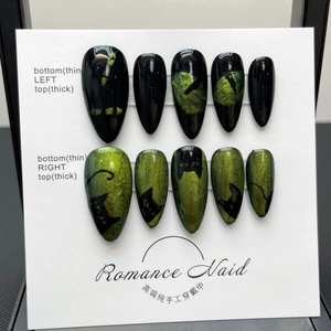Handmade black and green cat eye press-on nails with cat silhouette on long stiletto tips