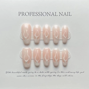 Detail of pink gradient press-on nails with white flame hand-painted patterns