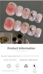 Detail of short peach and rainbow press-on nails with 3D elements and glossy finish