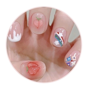 Detail of short round nails featuring 3D peach designs and rainbow star patterns