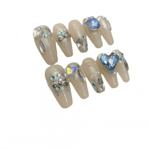 Handmade press-on nails with blue heart rhinestones, silver bows and glitter finish
