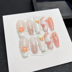 Handmade pink long coffin press-on nails with 3D flowers, pearls and glitter accents