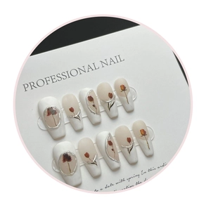 Detail of long ballerina nails featuring tulip art and silver metallic edges