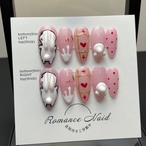 Handmade pink press-on nails set featuring 3D white bunnies and ribbon bow designs