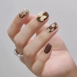 Brown coffee theme press-on nails with checkered patterns and 3D bow accents