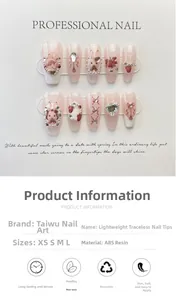 Detail of pink press-on nails with 3D bunny, strawberry, heart rhinestones and pearls
