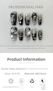 Detail of handmade press-on nails with black-grey gradient and snowflake rhinestone accents