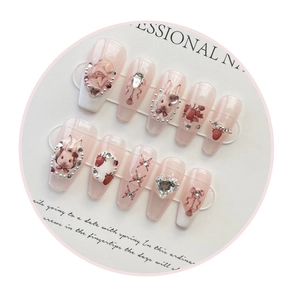 Macro view of long ballerina press-on nails with 3D bunny and heart diamond charms