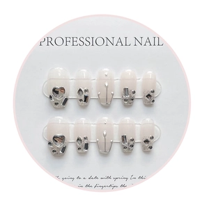 Detail of handmade French press-on nails with silver glitter and 3D heart rhinestones