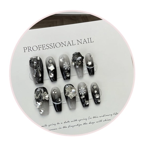 Detailed view of long trapezoid press-on nails with 3D snowflakes and rhinestones