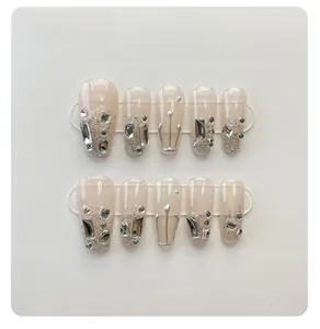Macro view of long coffin press-on nails with 3D rhinestones and silver liquid metal lines