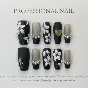 Handmade black rose press-on nails with 3D floral accents, pearls, and matte finish