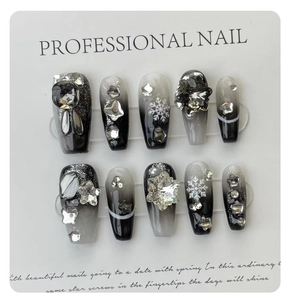Macro view of long ballerina press-on nails with winter snowflake and crystal embellishments