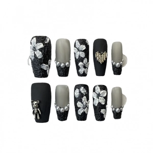 Handmade press-on nails with 3D white floral patterns and chrome bear accents