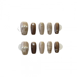 Handmade press-on nails featuring brown tweed patterns and elegant pearl embellishments