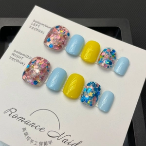 Handmade press-on nails with bright yellow, sky blue and colorful sequins on display card