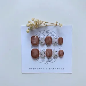 Brown marble gradient press-on nails with white floral patterns and gold trim