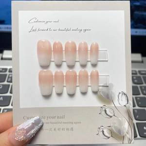 Pink and white ombre press-on nails in coffin shape with rose and pearl details