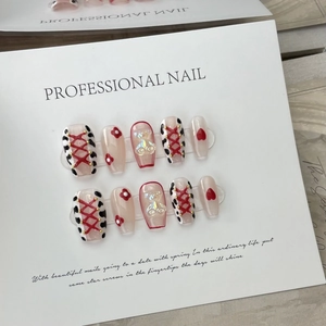 Handmade leopard heart press-on nails with 3D crystal bear and red cross tie design