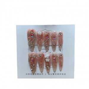 Pink ombre almond press-on nails with 3D white roses and sparkling rhinestones
