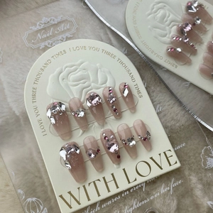 Handmade press-on nails with pink glitter finish and luxury rhinestone heart decorations