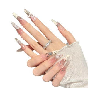 Sweet stiletto press-on nails with white polka dots, 3D bows, and pearl accents