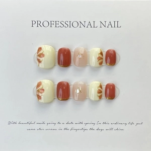 Handmade press-on nails set with red flower art and golden glitter foil details