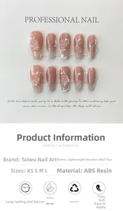 Macro detail of nude gradient press-on nails with 3D camellia flowers and pearl accents
