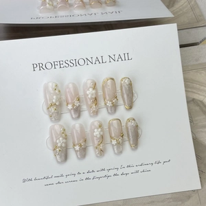 Handmade cat-eye press-on nails with 3D floral petals and gold lines in almond shape