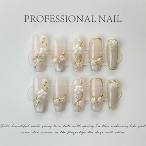 Handmade press-on nails with 3D floral accents, pink gradient, and cat-eye glitter finish