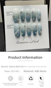 Detail of blue marble press-on nails with silver glitter and rhinestone accents