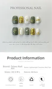 Macro detail of handmade press-on nails featuring green 3D heart relief and gold lines