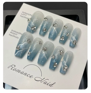 Detailed view of blue marble coffin press-on nails with silver glitter and rhinestones