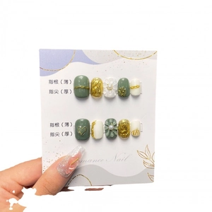 French luxury press-on nails with dark green marble, 3D camellia pearls, and gold foil accents