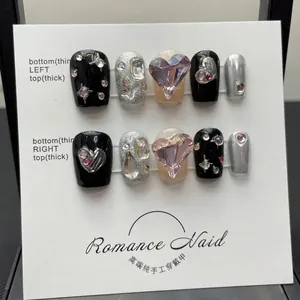 Handmade short press-on nails in black and nude with pink 3D heart rhinestones