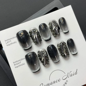Handmade black cat eye press-on nails with silver metal relief and grey rhinestones