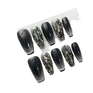 Handmade black cat eye press-on nails with luxury crystals and gothic 3D metal accents