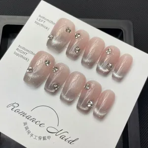 Handmade nude pink cat eye press-on nails with sparkling rhinestones and gradient effect