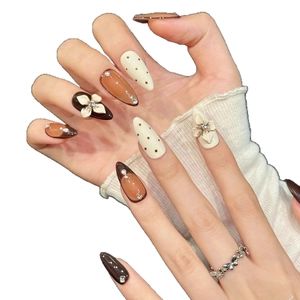 Short coffin press on nails featuring coffee brown cat eye gel and 3D floral accents