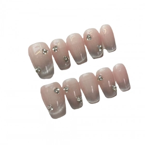 Pink and silver cat eye press-on nails with rhinestone accents in medium long square shape