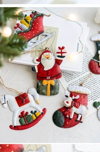 Detail of vintage hand-painted metal Christmas ornaments with Santa and sleigh icons