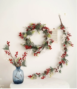 Detailed view of Christmas wreath and vine with red berries and natural pinecones