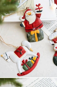 Close-up of vintage metal Christmas ornaments with Santa, horse and hemp rope hangers