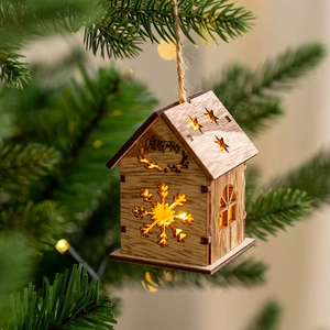 Lighted wooden Christmas house ornament with deer design and warm LED on a tree