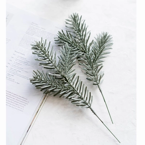 Artificial spruce pine needle branches in grey-green for Christmas home decor and wreaths